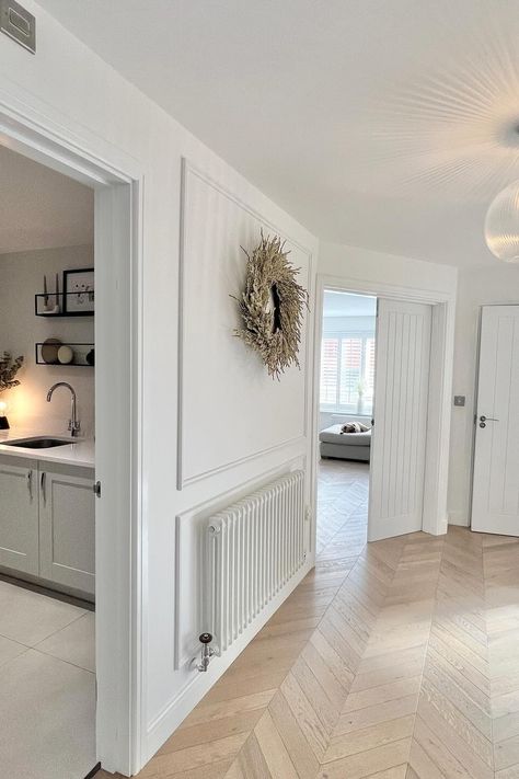 Cosy white Windsor columns in a beautiful minimal hallway over at @l.h_home. Shop the timeless rad.