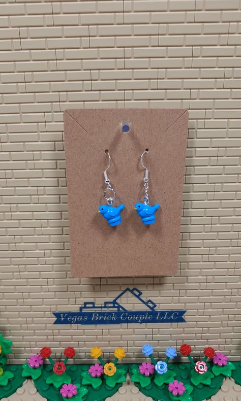 Custom Lego® Blue Bird dangling hook earrings with clear rubber backings. Perfect for Lego fans. These sterling silver plated, hypoallergenic earrings are handmade with new genuine Lego® pieces. Vegas Brick Couple LLC is not affiliated with LEGO®. This product is fan art and the LEGO logo, are registered trademarks of The LEGO Group, which does not authorize, sponsor or endorse this product.