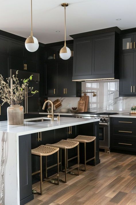 Kitchens with black cabinets exude a bold and modern aesthetic, adding a sleek and sophisticated touch to any space. The dark cabinetry creates a striking contrast against light countertops and backsplashes, making for a stunning and dramatic design statement. Modern Kitchen With Black Cabinets, Dark Kitchen With Gold Hardware, Dark Cabinets Kitchen White Countertops, Dark Kitchen Cabinets Light Countertop, Two Toned Black Kitchen Cabinets, White Countertops Black Cabinets, Modern Kitchen For Small Spaces, Bold Modern Kitchen, White Oak Floors Black Cabinets