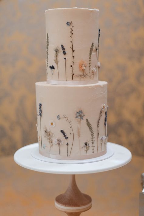 Edible pressed flower 2 tier buttercream wedding cake decorated with garden scene tyoe flowers in shades of blue, white and yellow | Hedsor House London UK 2 Tier Buttercream Cake, Wedding Cake Buttercream Flowers, Pressed Flower Cake, 2 Tier Wedding Cakes, Hedsor House, White Buttercream, Two Tier Cake, London Cake, Floral Wedding Cake