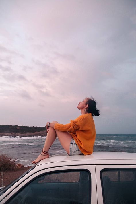 Woman Sitting On Top Of A Car | Stocksy United Sitting On Car Roof Aesthetic, Woman Sitting On A Rock, Sitting In The Back Of A Car, Sitting On Car Aesthetic, On Top Of Car Photoshoot, Sitting On Car Poses, Sitting On Top Of Car, Sitting On Hood Of Car, Women In Car