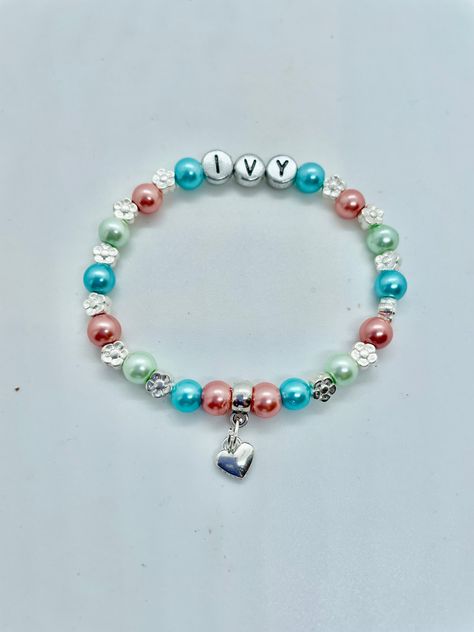 Unique beautiful coloured glass pearl bead bracelet complete with silver hearts or silver flowers at a SUPERB PRICE (limited time only). MANY OTHER FAMILY MEMBERS & WEDDING ATTENDANT Bracelets in my shop. All bracelets are designed and made to order with the charm and colour of your choice for your special Nan (Nanny, Nana, Grandma, Granny). Ideal surprise gift for a PREGNANCY or NEW BABY ANNOUNCEMENT, or Grandparents Day. What grandparent wouldn't love to wear a bracelet with their special gran Bracelet With Name, Pearl Bead Bracelet, Heart Gift Tags, Nanny Gifts, Fairy Charms, Granddaughter Gift, Childrens Jewelry, Heart Gifts, Personalized Bracelets