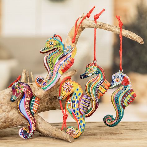 "When I was a little boy I loved everything that had to do with the sea and its creatures, especially seahorses. They are so morphologically different to the rest of the fish that I was fascinated by them. This childhood interest now inspires me to design these ornaments," confides José Arriola. The Guatemalan artisan handcrafts the ornaments of ceramic and paints each one with acrylics with different themes. The six ornaments hangs from bright red ribbons, and the set arrives in a traditional cotton pouch woven on a pedal-loom. Tiki Kitchen, Seahorse Ornament, Upcycled Handbag, Clam Shells, Ear Cuff Jewelry, Funny Earrings, Fish Ornaments, Art Sea, Ceramic Techniques