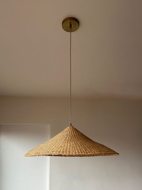 Our Sunhat pendant light is one of our most popular woven light fixtures. Handcrafted in a shallow cone shape from richly textured indigenous and sustainable elephant grass, this woven light shade is made by members of SWOPA, a women's organization for traditional arts in northern Ghana. Each natural grass lampshade is woven by hand and each is slightly uniquely different. Emitting a warm glow these woven pendant lights are ideal for any living space. SHADE DIMENSIONS* Size Height Diameter MEDIU Dining Pendant Light, Plug In Pendant Light, Interior Design Plan, Large Pendant Lighting, House On The Rock, Kitchen Pendants, Handmade Lighting, Pink Room, Brass Fittings