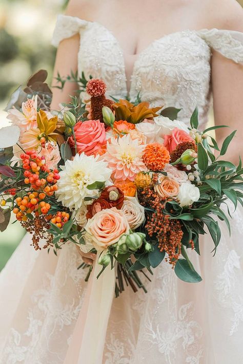 A fall bridal bouquet with dahlias, roses, and orange berries. Fall Colored Wedding Bouquet, Bridal Bouquet Garden Style, Peach Dahlia Bouquet, Colorful Fall Bouquet, Marigold Wedding Bouquet, Fall Wedding Bouquets October, Fall Wedding Flowers October, Fall Bouquet Wedding, Summer Flowers Wedding