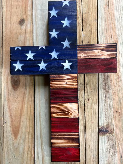 Rustic, wooden, upcycled, American flag cross.  Great patriotic gift for any occasion and anyone.  Crosses feature a keyhole slot for hanging on a screw or nail but also makes a great shelf sitter.   Made from wood that was otherwise destined for the burn pile but now makes a great way to display your faith and patriotism. Wooden Crosses Diy, American Flag Cross, Wooden Cross Crafts, Rustic Wooden American Flag, Wooden American Flag, Cross Flag, Cross Crafts, Diy Cross, Wooden Cross