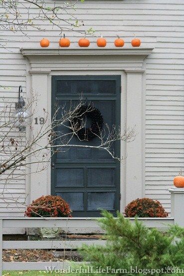 Longing for a ledge above my door after seeing this.  White pumpkins would be so cool too! Autumn Farmhouse, Front Door Trim, England Homes, Porch Doors, Primitive Homes, New England Fall, New England Style, Wonderful Life, Beautiful Doors