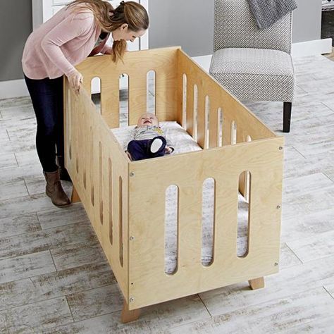 This bed/crib combo adapts to a growing child's needs and knocks down for storage. Simple plywood panels secured with knock-down fasteners make this bed fast to build, set up, and break down. Start with the crib, and when your child is old enough, swap in the toddler panel. It allows a little one to get in and out on their own, while preventing them from rolling out. When they outgrow the toddler bed, everything disassembles for storage in minimal space. Convertible Crib Plans, Wooden Baby Crib, Crib Woodworking Plans, Diy Crib, Modern Crib, Best Crib, Wood Crafting Tools, Woodworking Project Plans, Wood Magazine