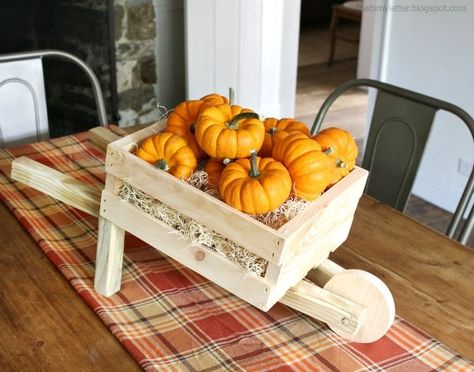 A DIY tutorial to make a tabletop size rustic wheelbarrow using a small crate. An easy Fall decor item you can make from simple wood pieces. #falldecor Wheelbarrow Decor, Wood Wheelbarrow, Rustic Wheelbarrows, Wooden Wheelbarrow, Diy Tabletop, Wheelbarrow Planter, Wood Wagon, Wooden Cart, Wheel Barrow