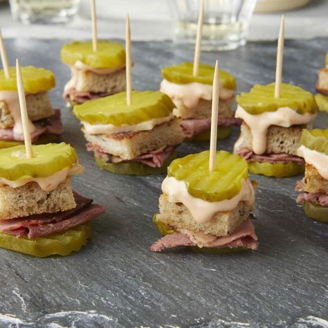 This pickle-on-a-stick appetizer has all the flavors of a classic Reuben sandwich in one small bite. Watch this crowd-pleasing no-cook appetizer disappear in a snap at a party, game-watch or tailgate. #appetizers #drinks #recipe #eatingwell #healthy Pickle Bites, Mini Aperitivos, Classic Reuben Sandwich, Reuben Sandwich Classic, Pickle Appetizers, Game Watch, No Cook Appetizers, Mini Appetizers, Reuben Sandwich