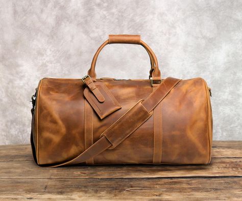 21" Leather Duffel Bag, Personalized Leather Travel Bag, Weekend Overnight Luggage Bag, Holdall, handbag, With Trolley Strap, Best Gift It can be Personalized and will be your best companion for travel and vacation... Features: * Dimensions : L 21" x H 11" x D 10" inches; * Made with worlds famous crazy horse leather; * 100% Genuine leather, retro style, simple, thick and durable; * It's a great gift for friends, colleagues or family! Personalization: Position: Luggage tag (Please refer to the picture for details.) We can hot stamp up to 6 capital letters on the luggage tag (including space). It can be Initials, name or phrase, Just leave your capital letters when placing your order. Personalized craft: Traditional hot stamping, not laser engraving！ Our products are handmade by skilled cra