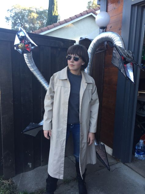 My daughter's Doc Ock (Dr. Octopus) costume. Halloween 2014. Made from semi-rigid dryer tubing that holds its own shape, wired to the back of an old hiking backpack frame. Frame sits under the trench coat and tubes come through holes cut in the back. Claws made from cardboard covered in foil tape. Lights are battery-operated bicycle lights. The whole thing was surprising light! Spidey And His Amazing Friends Doc Ock Costume, Dr Octopus Costume, Octopus Costume Diy, Doctor Octopus Costume, Doc Ock Costume, Halloween Pick Up Lines, Minimalist Halloween Costume, Doctor Octavius, Octopus Costume