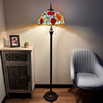 This traditional, incandescent-style lamp brightens any room. The unique stained-glass shade provides a warm ambiance perfect for cozy evenings. Enjoy the simplicity of a classic pull-chain design. Bloomsbury Market | Bloomsbury Market Aaniylah Tiffany Style Floor Lamp Stained Glass Rose Flowers LED Bulbs Included 64"H*16"W*16"D 64.0 H x 16.0 W x 16.0 D | 64" H X 16" W X 16" D | Wayfair Cottagecore Floor Lamp, Whimsical Floor Lamp, Big Floor Lamp, Tiffany Stained Glass Lamps, Tiffany Lamps Living Room Decor, Stainglass Lamps, Vintage Standing Lamp, Tall Lamps Bedroom, Grandmacore Decor