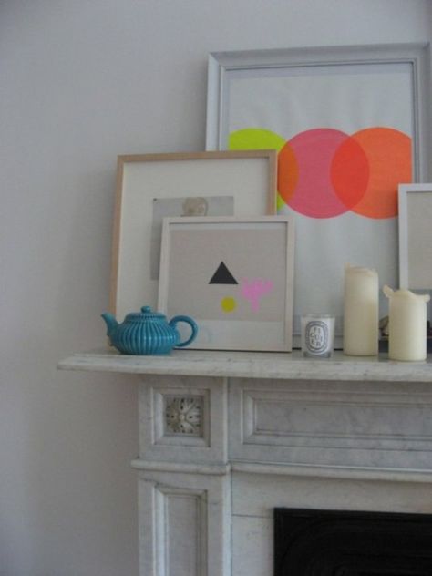 Colorful mantle #neon #shapes #art --- i want to buy neon scrap book paper and cut out circles and paste on canvas and either frame it or just tilt the canvas up. Styled Mantle, Colorful Mantle, Mantlepiece Decor, Neon Prints, Neon Shapes, Marble Mantle, Picture Placement, White Mantle, Shapes Art