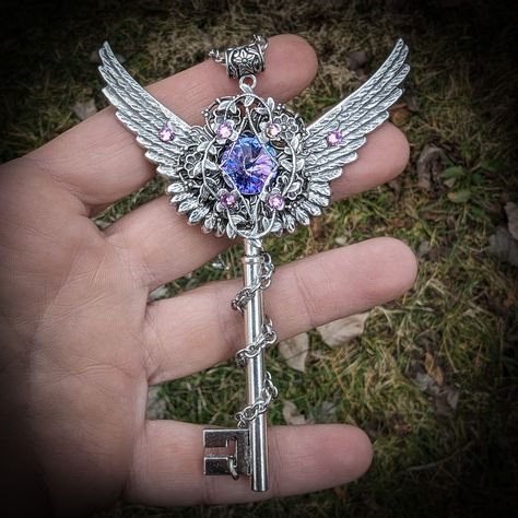 This large sterling silver plated fantasy key necklace features a 12mm Swarovski vitrail light crystal which changes colors in the sunlight (purple, pink and blue).  It is accented by smaller Swarovski rhinestones and gorgeous, very detailed, silver wings. It would make an excellent gift for those who loves fairies or magical things! Swarovski brand crystals are known for their brilliant sparkle and precision craftmanship making them the highest quality crystal in the world. The key pendant meas Necklace Chart, Fantasy Key, Faery Jewelry, Fantasy Jewelry Magic, Silver Fairy, Fantasy Necklace, Elven Jewelry, Magical Things, Light Crystal