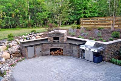 This patio idea includes a patio design, waterfalls and pond, outdoor kitchen island and even a pizza oven. The design was worked into an existing slope. Grill Garden, Outdoor Patio Kitchen, Outdoor Pizza Ovens, Outdoor Cooking Area, Patio Design Ideas, Charcoal Grills, Outdoor Patio Designs, Grill Area, Outdoor Kitchen Island