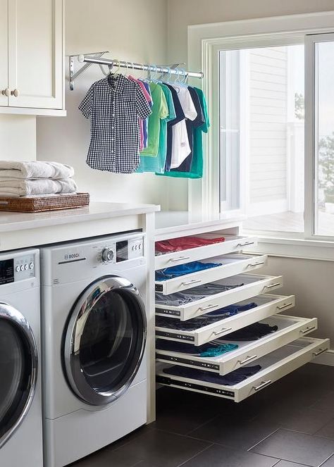 Stacked pull out drying racks are hidden behind white drawer fronts accented with satin nickel pulls and are positioned beneath a drying rod. Laundry Room Drying Rack, Sweater Drying Rack, Drying Room, Stylish Laundry Room, Dream Laundry Room, Clothes Hanging, Laundry Design, Drying Racks, Farmhouse Laundry Room