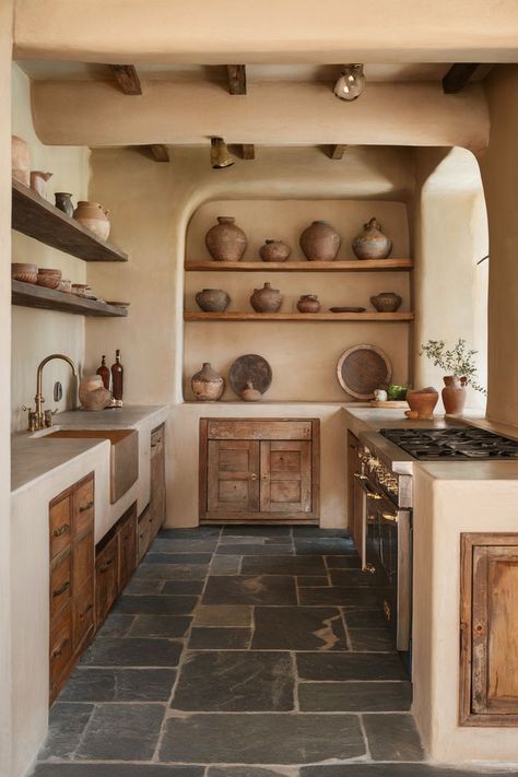 A modern earthy kitchen with open shelves, rustic pottery, and a soft, neutral color palette for a warm and inviting feel. Earthy Modern Kitchen, Earthy Kitchen Decor, Earthy Kitchens, Earthy Kitchen Ideas, Saree Boutique, Earthy Interior, Southwest Kitchen, Dream Architecture, Earthy Kitchen