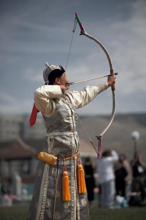 A female archer in elegant Mongolian dress during the Naadam Festival. (Pius Lee/Daily Travel Photos) Naadam Festival, Female Archer, Mongolian People, Bows And Arrows, Traditional Archery, Bow And Arrow, We Are The World, People Of The World, World Cultures