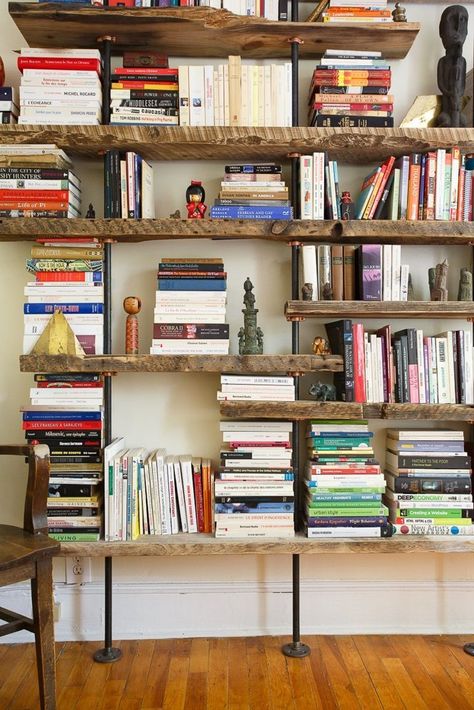 Pipe and Wood Shelving from: John & Fabien's Elemental Home — House Tour | Apartment Therapy Rustic Industrial Living Room, Rustic Bookshelves, Rustic Industrial Furniture, Lots Of Books, Rustic Bookshelf, Industrial Design Furniture, Industrial Livingroom, Regal Design, Home Libraries