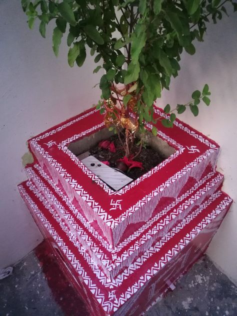 Maa tulsi mandir is decorated with red and white paint, traditionally geru and rice paste was used. Tulsi Vivah Painting, Tulsi Painting, Tulsi Pot Design, Pahadi Culture, Tulsi Puja, Tulsi Pot, Tulsi Vivah, Tulsi Plant, Alpona Design