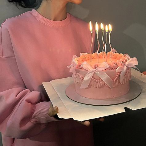 A girl in a pink hoodie holding her birthday pink cake with ribbons and silver candles :) Aesthetic Small Cake, Ribbon Birthday Cake, Pastel Pink Cake Aesthetic, Small Pink Cake, Pink Birthday Cake Aesthetic, Elegant Pink Cake, Pink Mini Cake, Pink Ribbon Cake, Pink Cake Aesthetic