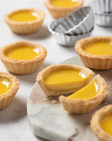 It’s National Egg Day, and we’re celebrating with a timeless treat: Egg Custard Tarts!  These beauties combine a buttery, melt-in-your-mouth crust with a glistening, vanilla-scented custard that’s rich and oh-so-satisfying.  Delicate yet decadent, they’re impossible to resist! These tarts are a staple in Chinese bakeries for a reason, and they're perfect for any occasion. Custard Tartlets, Egg Custard Tarts, National Egg Day, Egg Tart Recipe, Custard Tarts, Tartlets Recipe, Baking School, Afternoon Tea Recipes, Recipes From Around The World