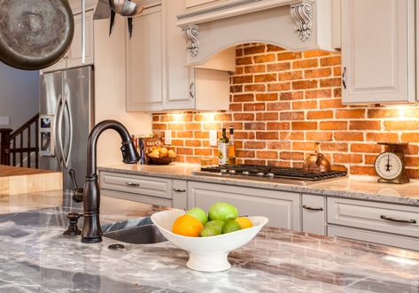 Kitchen with marble countertop island and brick backsplash White Brick Backsplash, Cleaning Brick, Traditional Kitchen Remodel, Brick Backsplash Kitchen, How To Clean Brick, Brick Kitchen, Brick Backsplash, Kitchen And Bath Remodeling, Backsplash Kitchen