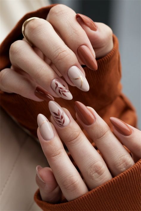 Embrace the essence of the season with these elegant autumn simple fall nail ideas that are effortlessly chic. Featuring muted tones of burnt orange and deep burgundy, this nail style encapsulates the warmth and beauty of autumn leaves. The addition of subtle gold accents brings just the right touch of glamour, making your nails the perfect accessory for any fall outfit. Dive into this seasonal delight and elevate your manicure game! Fall Drip Nails, Manicure Fall Nails, Simple Nail Ideas For Fall, Negative Space Nails Fall, Simple Fall Nail Designs Leaves, November Nails Short Almond, Demure Fall Nails, Leave Nails Fall, Fall Nails Modern