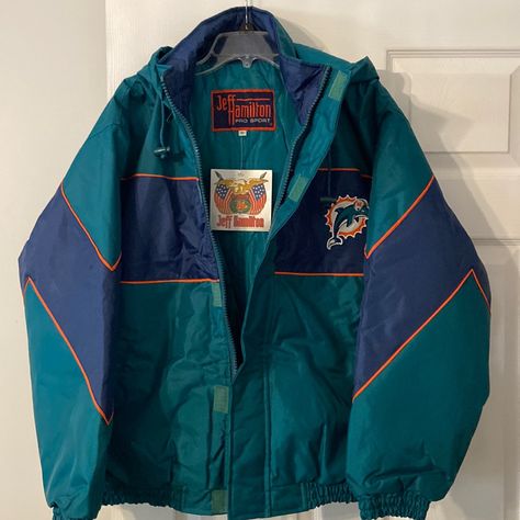 Vintage Jeff Hamilton An Original Pro Sport Dolphins Jacket Size M Brand New With Tag It’s Comes With Hoodie Hat It’s Very Beautiful Dolphins Jacket That I Ever Seen. No Rain Or Snow Can’t Do Anything 100% Naylon Thick Ski Jacket Style, Teal ,Orange, And Navy Blue Color Football Florida Team Sport Bust 50” Long 26” Sleeve Long 23” From Top Armpit To End Sleeve 19” Vintage Hoodies Aesthetic Men, Sports Jacket Outfit Men, Vintage Hoodies Aesthetic, Sports Jacket Outfit, Beautiful Dolphins, Vintage Sports Jacket, Retro Jackets, Green Outerwear, Jeff Hamilton