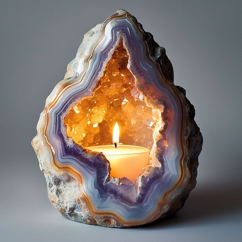 The Geode Candle is a stunning, nature-inspired piece that combines the beauty of crystals with the warmth of candlelight. Shaped like a real geode, the outer surface mimics the rugged texture of stone, while the inside reveals intricate, crystal-like formations that sparkle when illuminated. Hand-poured with premium, long-lasting wax, each candle boasts a unique, gemstone-like appearance, offering a blend of art and ambiance. As the candle burns, it casts a soft, radiant glow, creating a soo... Geode Candle, Luxurious Candles, Candle Design, Decor Market, Diy Candles Scented, Stunning Nature, Unique Products Design, Crystal Geode, Wedding Tables