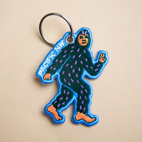 2.29" x 3.25" double-sided embroidered keychain with a key ring. Outdoorsy Boyfriend Gifts, Patch Keychain, Embroidery Keychain, Plushie Keychain, Thesis Ideas, Voynich Manuscript, Bigfoot Sasquatch, Mens Hats, Patch Embroidery