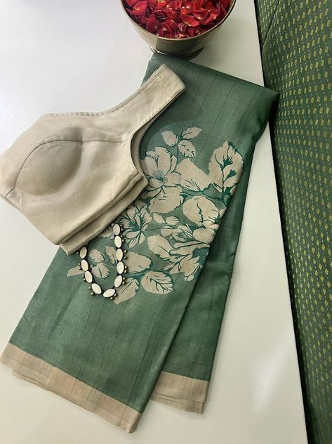 It's fascinating how a simple switch in colors can create a completely different effect. Presenting a handloom Tussar saree in Russian green with buttercup floral prints in beige along the bottom. The elegance is heightened with a beige border, blouse, and palla, evoking a charm that words fail to do describe. Paired effortlessly with our beige organza blouse and accented by a terracotta necklace, this ensemble exudes understated sophistication. Color Combinations For Clothes Women, Terracotta Necklace, Unique Sarees, Tussar Saree, Cotton Blouse Design, Sarees For Girls, Simple Saree Designs, New Saree Designs, New Saree Blouse Designs