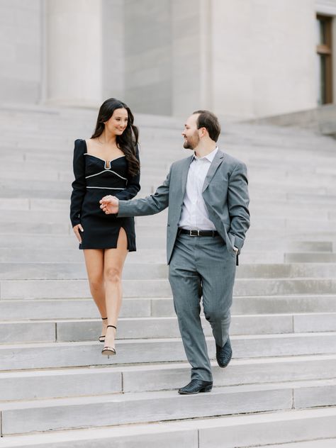 Couple walks down steps of Capitol building for engagement photos with groom in grey suit and bride and little black dress Dressy Engagement Photos, Classic Engagement Photos, Hot Springs Arkansas, State Capital, Little Rock Arkansas, Arkansas Wedding, Arkansas State, Couples Engagement Photos, Classic Engagement