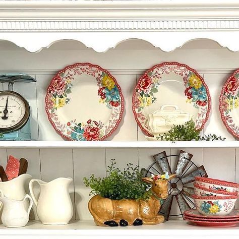 Pattie on Instagram: "I took down my bunnies and carrot patch decor and decided to do a farmhouse display with my Pioneer Woman Fancy Flourish dishes and my new PW cow planter! 🩵🐂🌸🌺🌼🩵 #farmhousehutchdecor #farmhousedecor #pioneerwoman #pioneerwomandishes #pioneerwomanlove #pioneerwomanaddicts #ironstonepitchers #vintagescales #raedunnll #raedunnlove #raedunn #vintagekitchenware" Pioneer Woman Fancy Flourish, Farmhouse Hutch Decor, Cow Planter, Pioneer Woman Decor, Pioneer Woman Kitchen Design, Pioneer Woman Dishes, Carrot Patch, Hutch Decor, Pioneer Woman Kitchen