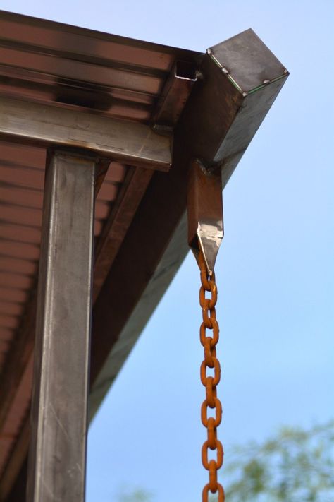 Here's everything you need to know about rain chains, an eco-friendly alternative to downspouts including costs, hardware fittings, and installation tips. Wood Pergola Kits, Pergola Cost, Roof Drain, Corrugated Metal Roof, Rain Chains, Wooden Pergola, Backyard Pergola, Rain Chain, Pergola With Roof