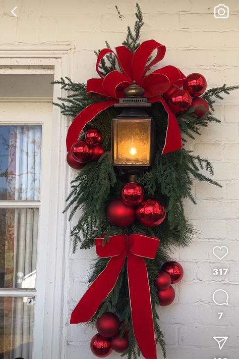 Red Front Door Christmas Decorations, Red And White Christmas Swag, Outdoor Xmas Decorations Front Yards, Xmas Front Porch Ideas, Lantern Wreath, Lantern Swag, Outside Christmas Decorations, Christmas Planters, Christmas Floral Arrangements