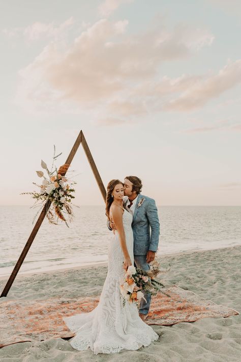 Boho beach ceremony decor with wood triangle arch, modern boho florals, and boho ceremony rug. Wood Triangle Arch, Beach Ceremony Decor, North Captiva Island, Decor With Wood, Boho Ceremony, Intimate Beach Wedding, Beach Wedding Arch, Wood Triangle, Boho Florals