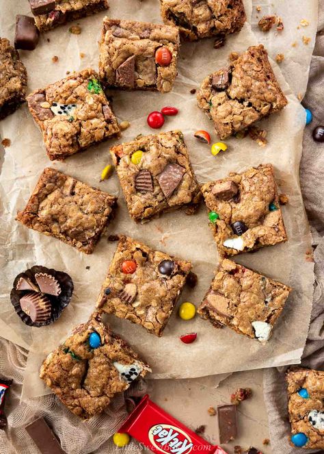 These thick and chewy cookie bars are loaded with Halloween chocolates and hearty rolled oats. They are super easy to make and an excellent way to use up any leftover Halloween candy. Snickers Cookie Bars, Halloween Candy Cookies Leftover, Leftover Candy Cookies, Candy Bar Cookie Bars, Leftover Halloween Candy Cookie Bars, Leftover Halloween Candy Cookies, Halloween Candy Cookie Bars, Candy Bar Recipes, Candy Cookie Bars