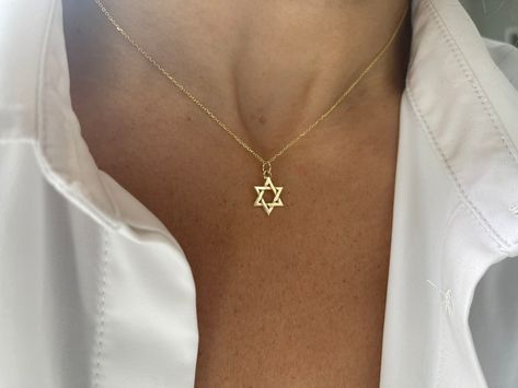 Star of David Necklace / 14k Gold Star of David Necklace / Small Star of David Pendant  this listing is for one star of David this is available with or without a chain. Please choose accordingly at check out. SOLID 14K YELLOW GOLD STAR OF DAVID NECKLACE . THE STAR AND CHAIN IS SOLID 14K YELLOW GOLD.  FREE SHIPPINGWITHIN THE USA METAL: 14k solid gold 585  STYLE: STAR OF DAVID NECKLACE PURITY: 14K SIZE: 11.5 mm AS IT IS WITH THIS ITEM ALL MY PIECES ARE HAND MADE. AND I STAND BEHIND EVERY PIECE. SA Dainty Star Of David Necklace, Dainty Yellow Gold Star Of David Necklace, Gold Star Of David Necklace For Gift, Celestial Gold Star Of David Necklaces, Gold Star Of David Necklace, Star Of, David Star, Star Of David Necklace, Star David