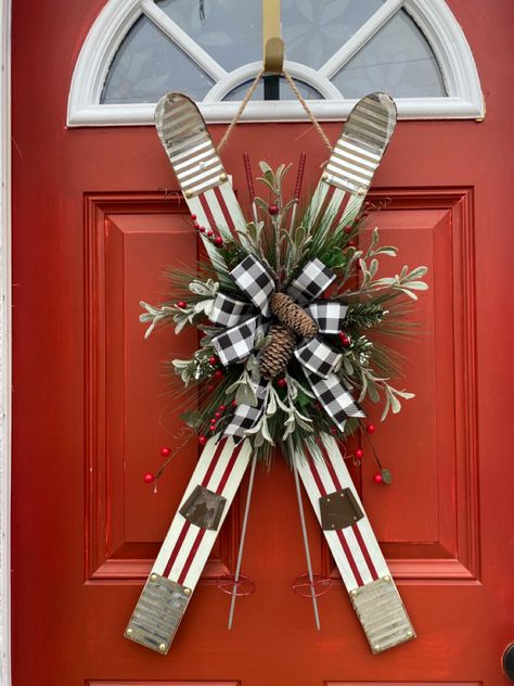 What an adorable Door Hanger Wreath. Set of wooden skis in a crisscross position. They are off white with Red pin stripes. In the center is whispering pines, frosted picks and berries with a gorgeous buffalo plaid ribbon to create a bow that has frosted pine cones in the middle. If you wanting something different than a wreath that you can leave up all winter look no further. This is your masterpiece. These would be great for a cabin or a lake house. Pine cones may vary from ones each other! Ski Cabin Decor, Wreaths Winter, Mountain House Decor, Ski House Decor, Mountain Condo, Ski Room, Ski Condo, Christmas Florals, Ski Decor