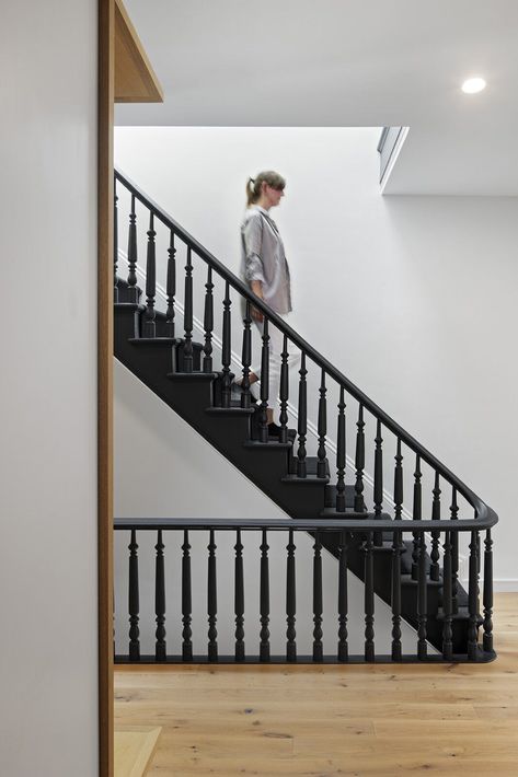 The well-preserved staircase railing and spindles are now painted matte black. #blackstaircase #townhouseremodel #renovation Painted Staircase Railing, Edwardian Staircase, Painted Stair Railings, Black Stair Railing, Staircase Spindles, Black Railing, Black Staircase, Stair Spindles, Painted Staircases