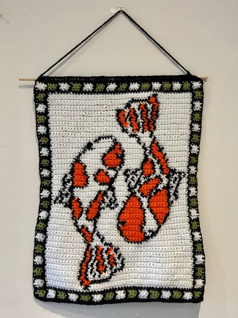 Make your own koi fish crochet tapestry! This pattern includes instructions that have been written out in 3 different ways:  1. Stitch Fiddle Graph  2. Colour Block Instructions  3. Written Instructions  Materials needed:  - 4mm crochet hook (can use other sizes at your own discretion) - White DK wool  - Black DK wool  - Green DK wool  - Orange DK wool  - Dowel rod - Scissors - Darning needle Stitches used in pattern:  - Single chain (sc) - Double chain (dc) This pattern uses US crochet terminology.  Pattern is in English.  This product is a DIGITAL FILE, downloaded as a PDF that will be available instantly once payment has been received.  Please do not hesitate to contact me if you have any questions! Thank you :) Crochet Tapestry Pattern, Fish Crochet, Stitch Fiddle, Crochet Parrot, Crochet Wall Art, Tapestry Pattern, 4mm Crochet Hook, Crochet Wall Hangings, Tapestry Crochet Patterns