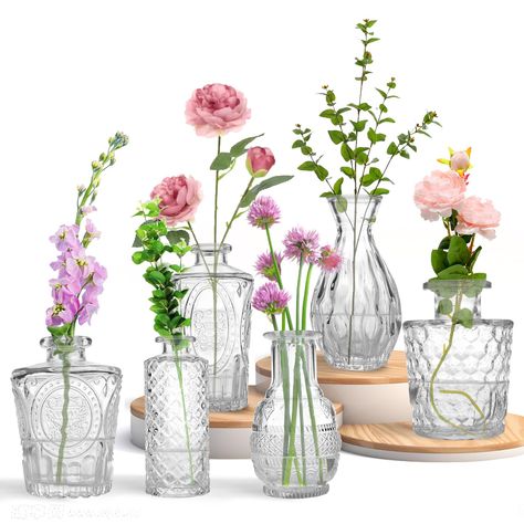 PRICES MAY VARY. Versatile and Stylish: These glass bud vases are perfect for adding a touch of elegance to any occasion, from weddings to home decor. Perfect Size for Flowers: With their small size, these glass flower vase are ideal for displaying single flowers or creating stunning floral centerpieces. Durable and Clear: Made from high-quality glass, these glass vases are sturdy and transparent, allowing the beauty of your flowers to shine through. Great Value: This bulk pack includes multiple Single Flower Vase Wedding, Small Vase Flower Arrangements, Bridal Shower Floral Centerpieces, Ginger Wedding, Glass Vase Wedding Centerpieces, Decorating With Flowers, Small Vases With Flowers, Bud Vases Arrangements, Wildflower Centerpieces