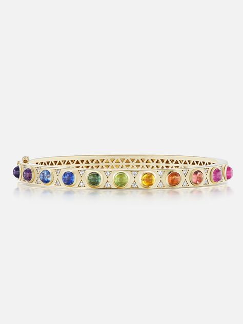 18k yellow gold hinged bangle with rainbow sapphire cabochons and diamond details. The perfect way to elevate your wrist stack, the Rainbow Cabochon bangle is one-sided and features a comfortable single hinge for ease of wear. Looks great alone or paired with friends! Made to order. The current lead time is 8-10 weeks. 18k Gold Bangle, Wrist Stack, Wrist Stacks, Rainbow Sapphires, Rainbow Jewelry, Swiss Blue Topaz, Hinged Bangle, Bridal Fashion, Yellow Sapphire