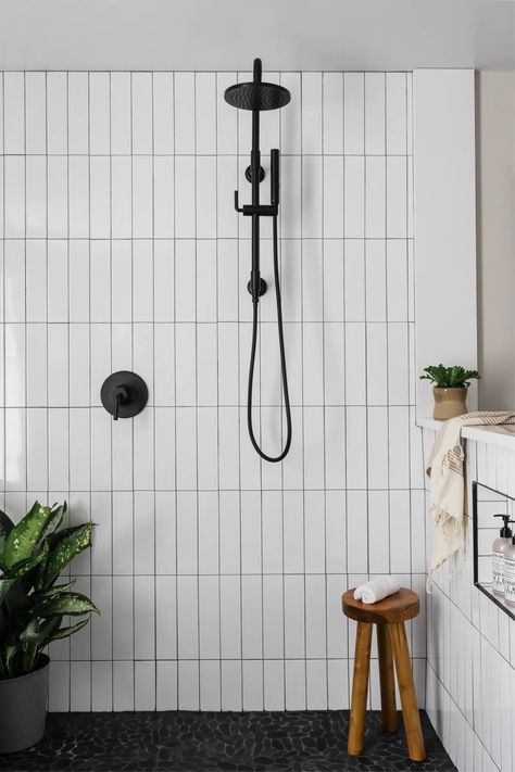 A Dated Brown Bathroom Becomes a Modern-Day Retreat | Architectural Digest Hexagon Tile Shower Wall, Black Tile Bathroom Floor, Vibe Bathroom, Black Tile Bathrooms, Black Floor Tiles, Subway Tiles Bathroom, Full Bathroom Remodel, Cool Bookshelves, Shower Floor Tile