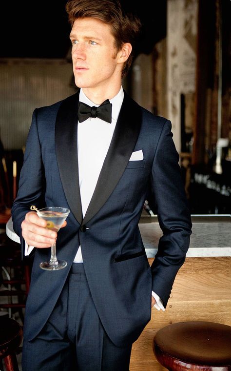 Inspired by James Bond's iconic tuxedo, it features a midnight blue twill wool with the standard tuxedo satin trimmings on the lapel, pocket besom, buttons and pant outseam. The one button dinner jacket is half canvassed with a black paisley lining, the trousers come with adjustable side tabs and suspender buttons. Blue Tuxedo Wedding, Navy Groom, Navy Tuxedos, Blue Tuxedo, Prom Blazers, Navy Blue Tuxedos, Wedding Tux, Blue Suit Men, Custom Made Suits