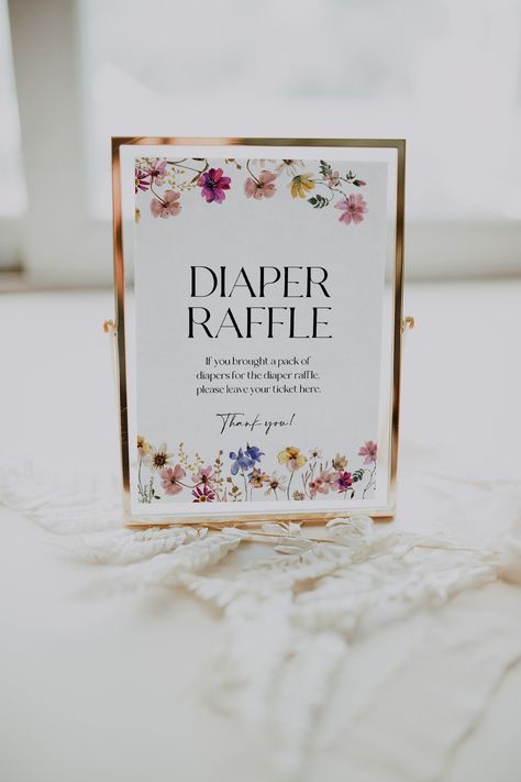 Baby shower Diaper Raffle sign template with colorful flowers and wildflowers. Instant access through Templett, fully customizable, no software needed.  Check the demo and coordinating templates using the links below. Ⓜ️ MATCHING TEMPLATES:  https://etsy.me/3CqImOr (copy the link in a web browser) 📦WHAT IS INCLUDED: Diaper raffle sign: 5x7 and 8x10 inches 💻 DEMO LINK: https://templett.com/design/demo/visual/20922467,20922468 🖨️ PRINT using our partner's reliable printing service:  https://bit Flower Baby Shower Theme, February Baby Showers, Floral Baby Shower Decorations, Diaper Raffle Sign, Wildflower Baby Shower, Baby In Bloom, Sprinkle Baby Shower, Elegant Baby Shower