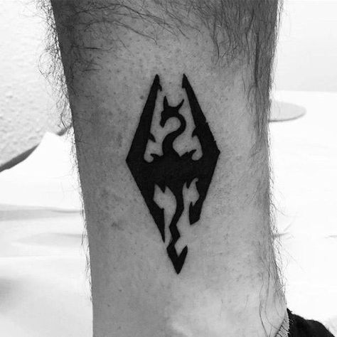 Small Simple Lower Leg Guys Tattoos With Skyrim Design Skyrim Tattoo, Video Game Tattoos, Tatuagem Masculina Pequena, Gamer Tattoos, Symbol Tattoo, Small Tattoos Simple, Leg Tattoo Men, Gaming Tattoo, Tattoo Videos