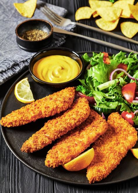 Breaded fish fillet with salad on black plate royalty free stock photo Breaded Fish Fillet, Restaurant Salmon, Salmon Fried, Breaded Fish, Fish Salad, Baked Fish, Fish Fillet, Yellow Mustard, Black Plates